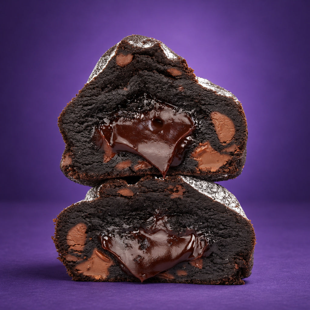 Massive Eruption cut open with molten fudge, stacked on a purple set