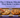 A finger presses a soft, perfectly done cookie next to an overbaked one on a baking sheet, under the title "The 2-Minute Mistake That Ruins Cookies."