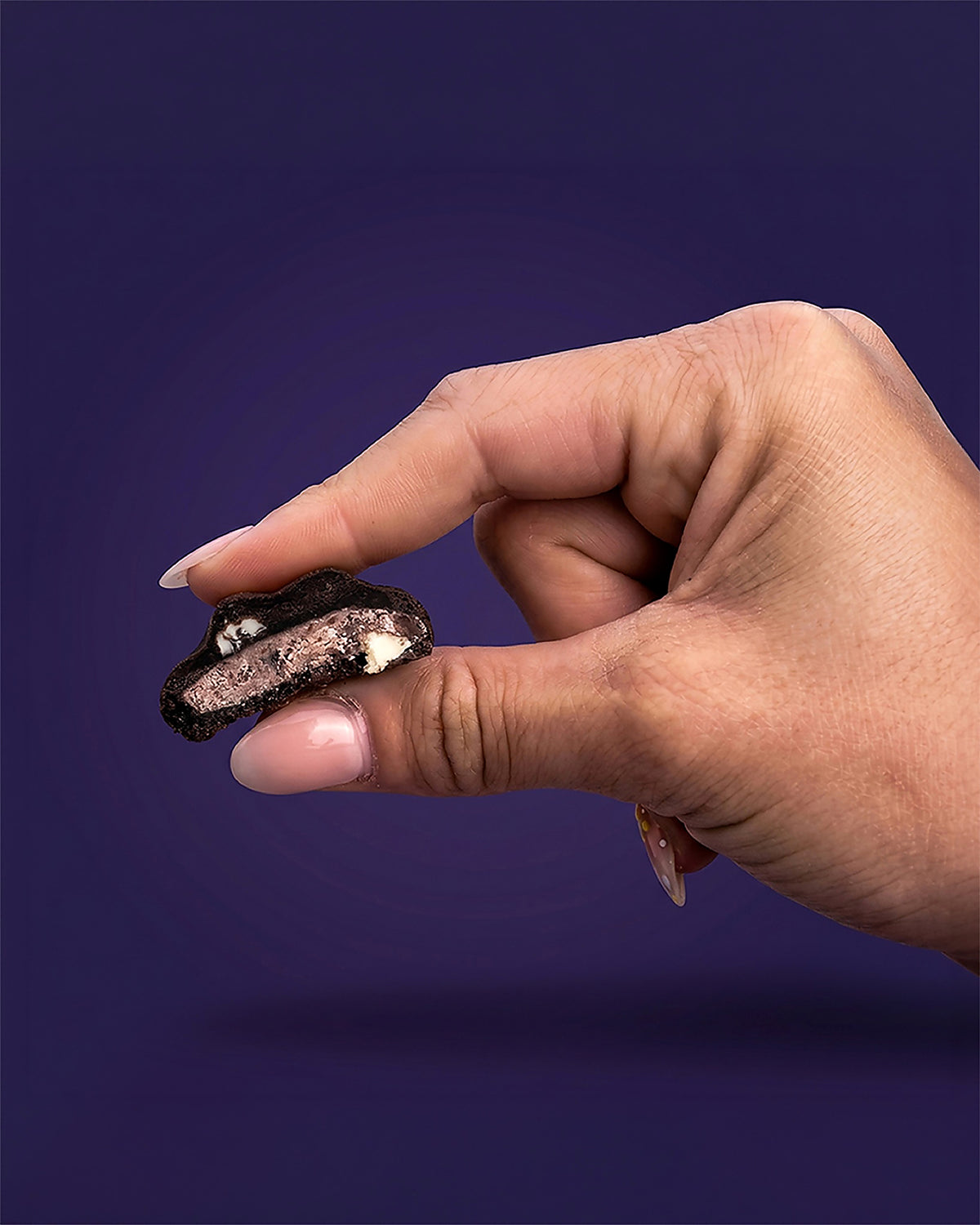 Bite-sized Black Beauty stuffed cookie, a black cocoa cookie with chocolate sandwich cookie pieces and white chocolate chips