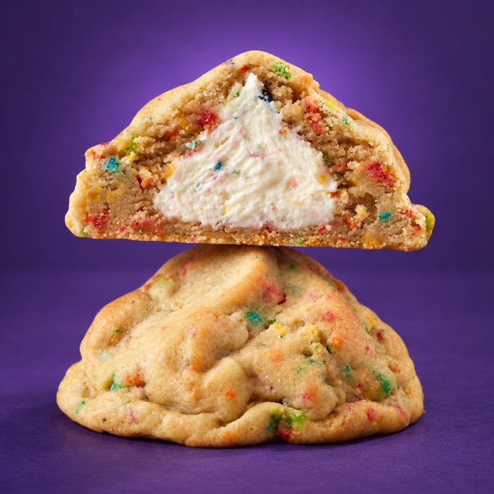 Yabba Dabba cookie broken open to show the creamy fruity frosting center